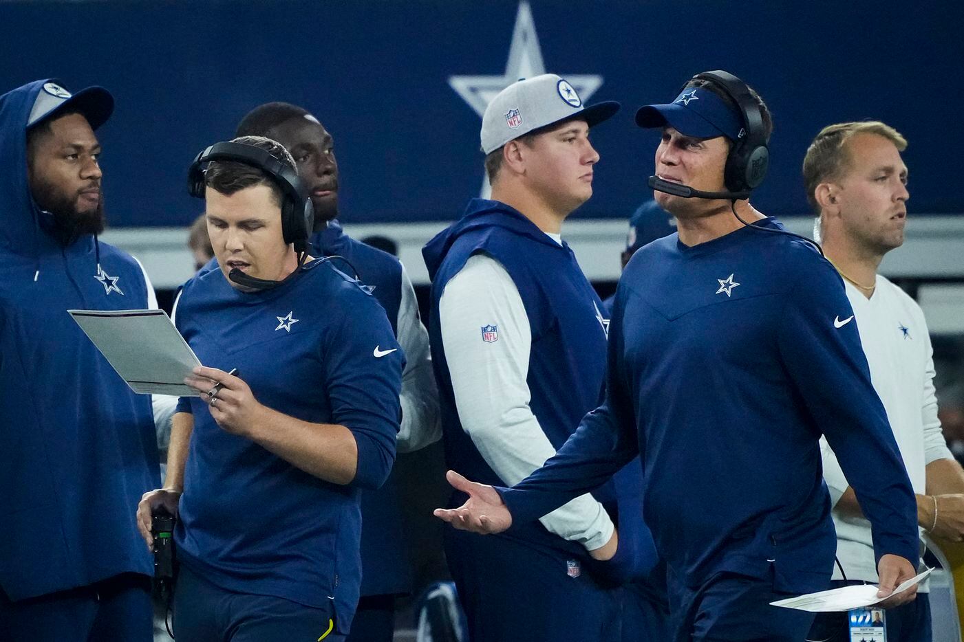 Dallas Cowboys offensive coordinator Kellen Moore (left) works on the sidelines during the...