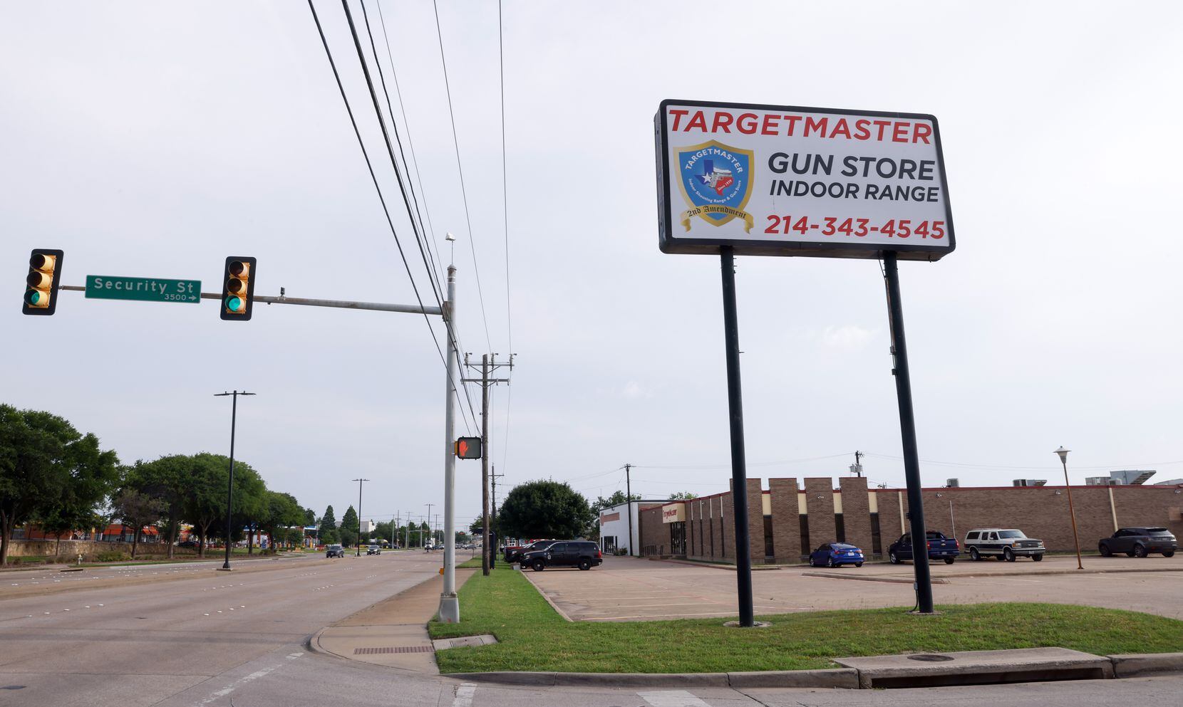 A sign for TargetMaster, a gun shop and indoor shooting range, sits on the edge of the...