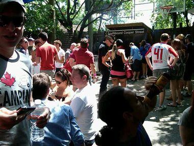 Crowds gather on the basketball court during 'Suck Fest,' a Cajun crawfish boil at the...