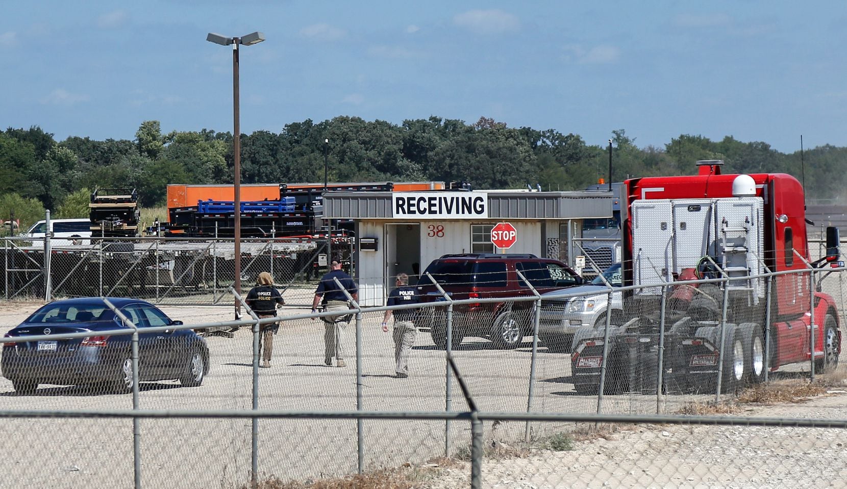 U.S. Immigration and Customs Enforcement agents are seen at the receiving gates of Load...