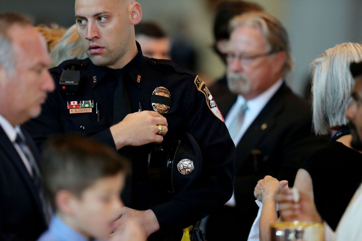 Addison officer Coffelt takes communion during the funeral for Dallas police sergeant Michael Smith.