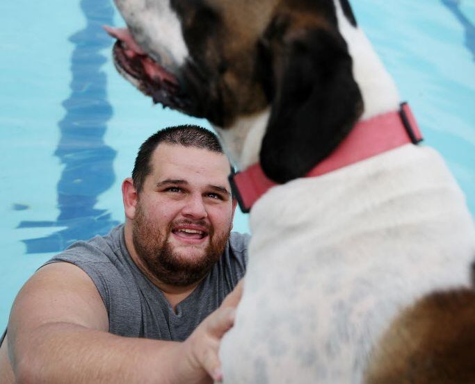 Shane Nunneley plays with his dog during Paws in the Pooloza. 