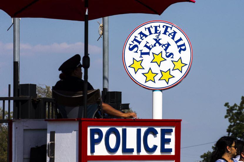 A Dallas Police officer keeps watch over an entrance gate at the State Fair of Texas on the...