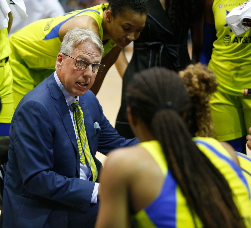 Dallas Wings head coach Brian Agler speaks with his players during a first half timeout...