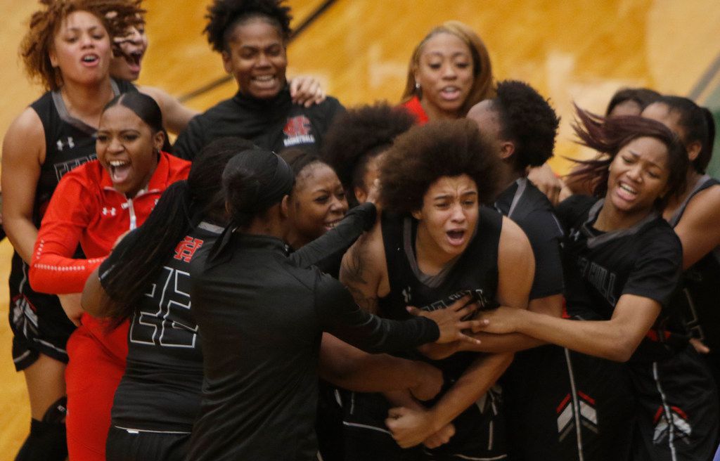 Cedar Hill forward Destinee McDowell (12) is mobbed by teammates after sinking a jump shot...
