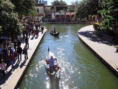 Gondolas move along the water before stopping for passengers at the revived Canal Fest, in...