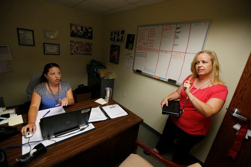 Tarrant County CPS investigator Kelli Bailey (right) talks to her supervisor, Denee...