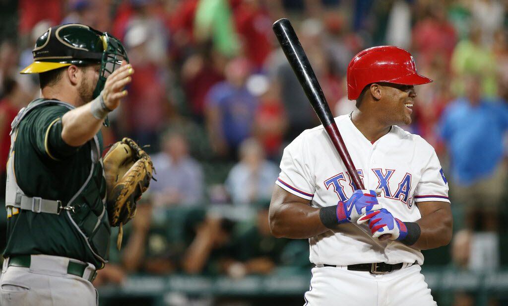 Oakland Athletics catcher Stephen Vogt (21) catches the pitch as Texas Rangers third baseman...
