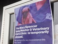Signs taped to the doors of the SPCA of Texas' Mary Spencer Spay/Neuter & Wellness Clinic on...