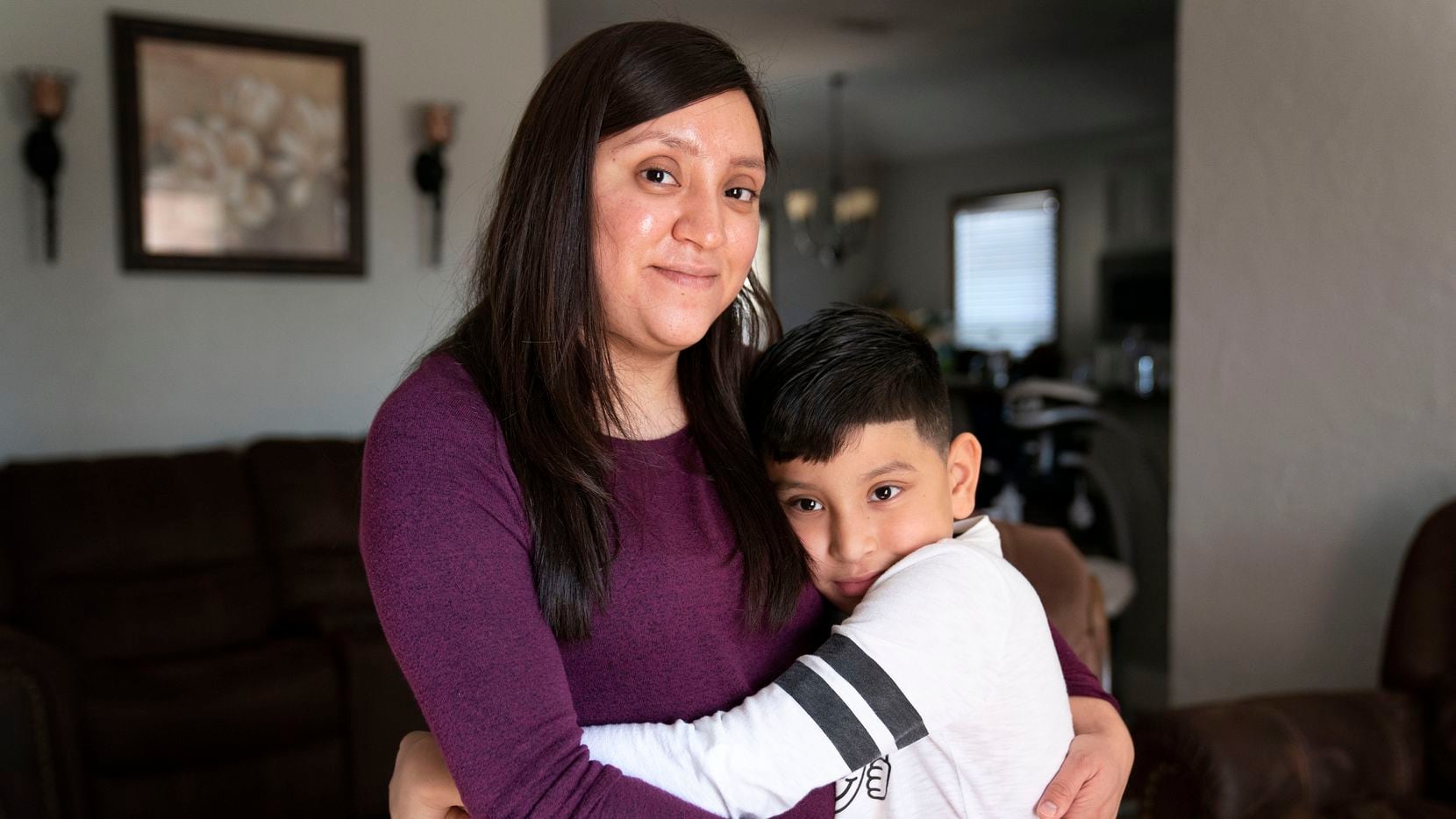 Cynthia Medina, 27, poses for a portrait with her son Aaron Villegas, 8, at her home in West...