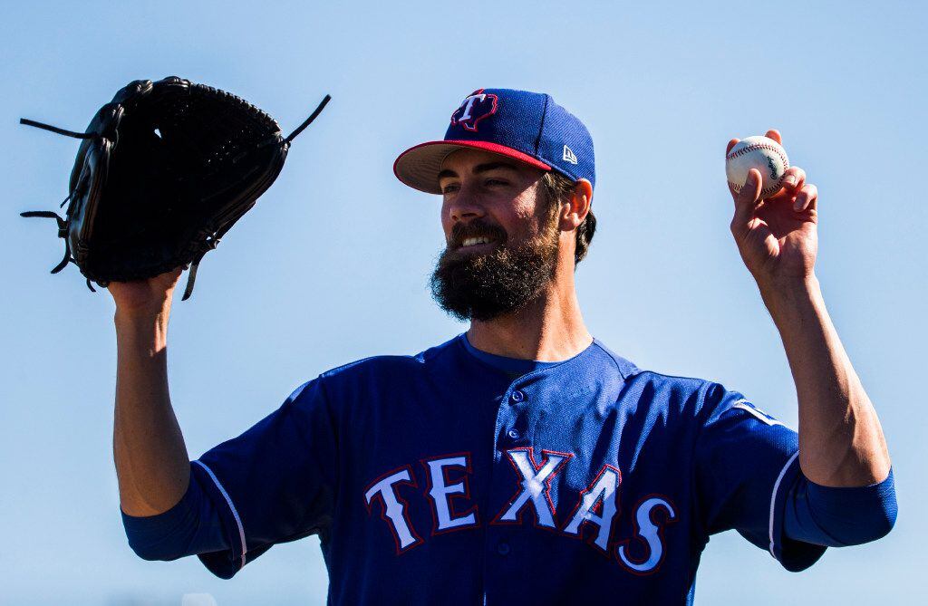 Texas Rangers starting pitcher Cole Hamels (35) prepares to pitch during a spring training...