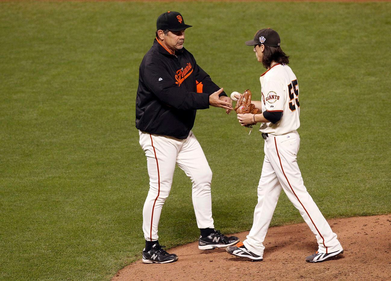San Francisco Giants starter Tim Lincecum is relieved from the game as he hands the ball to...