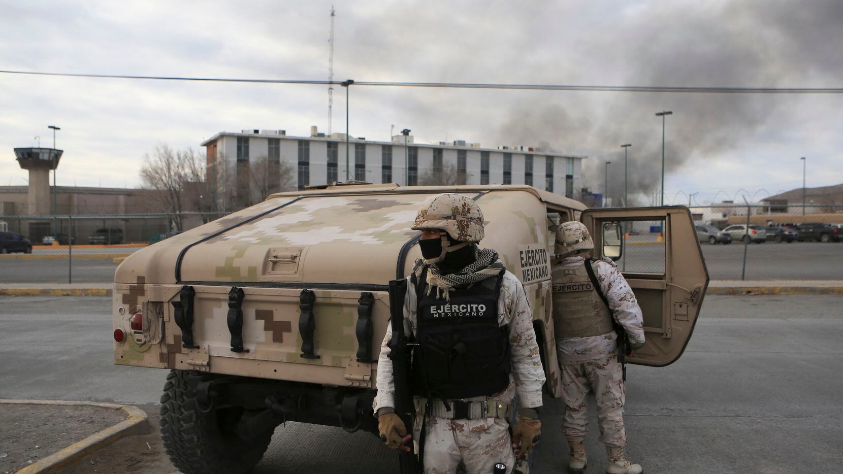 Mexican soldiers stand guard outside a state prison in Ciudad Juarez, Mexico, Sunday Jan 1,...