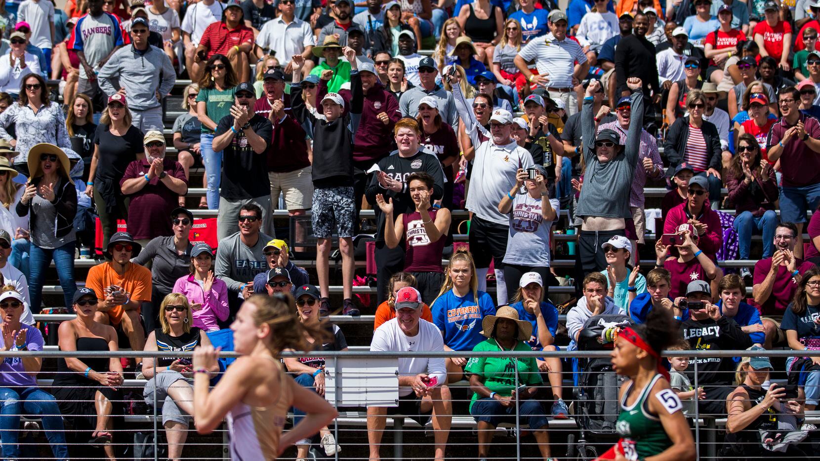 People watch as 5A girls 100 meter dash competitors sprint by during the TAPPS State...