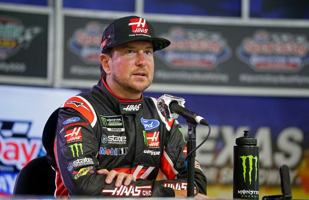 Driver Kurt Busch speaks to the media after he takes the pole position at qualifying for...