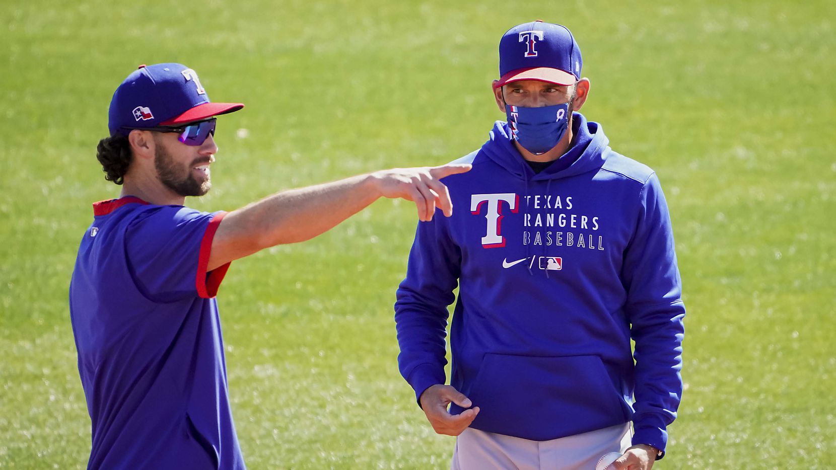 Texas Rangers infielder Charlie Culberson (left) talks with manager Chris Woodward during a spring training workout at the team's training facility on Friday, Feb. 26, 2021, in Surprise, Ariz.