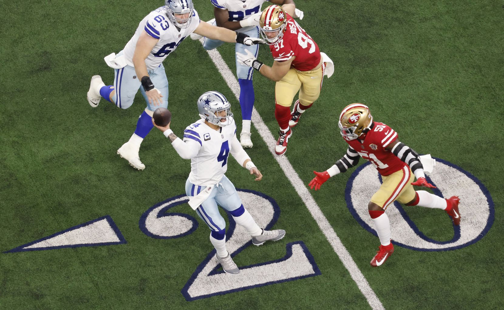 Dallas Cowboys throws a first quarter pass as he’s pressured by San Francisco 49ers outside...