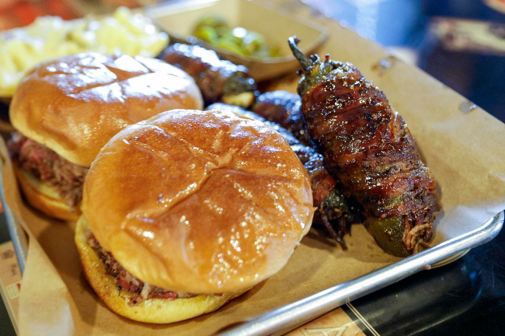 BBQ sandwiches and a Texas Twister are seen on a plate at Hutchins BBQ, Friday, July 28,...