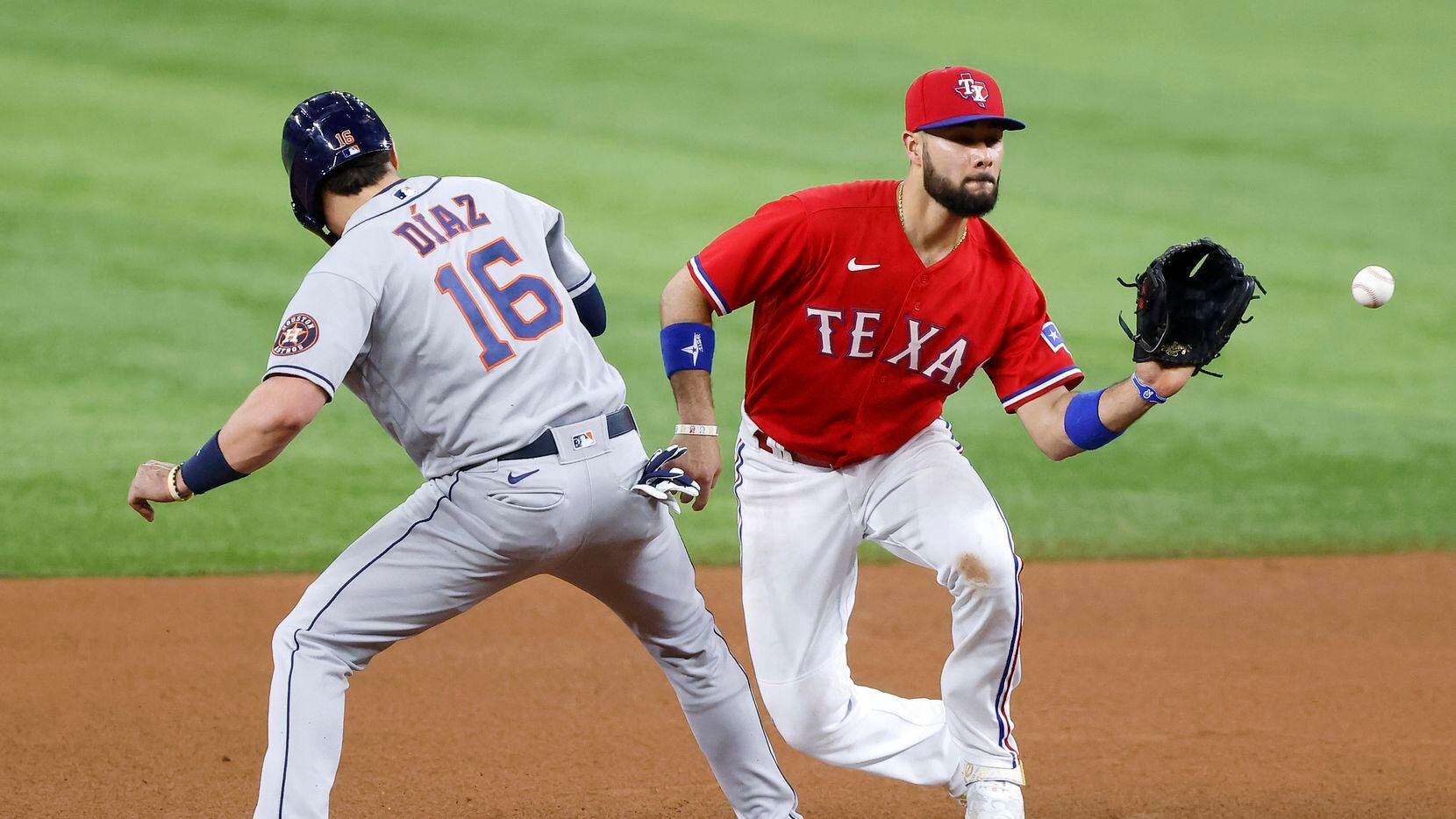 Texas Rangers shortstop Isiah Kiner-Falefa (9) tries to pick off Houston Astros shortstop...