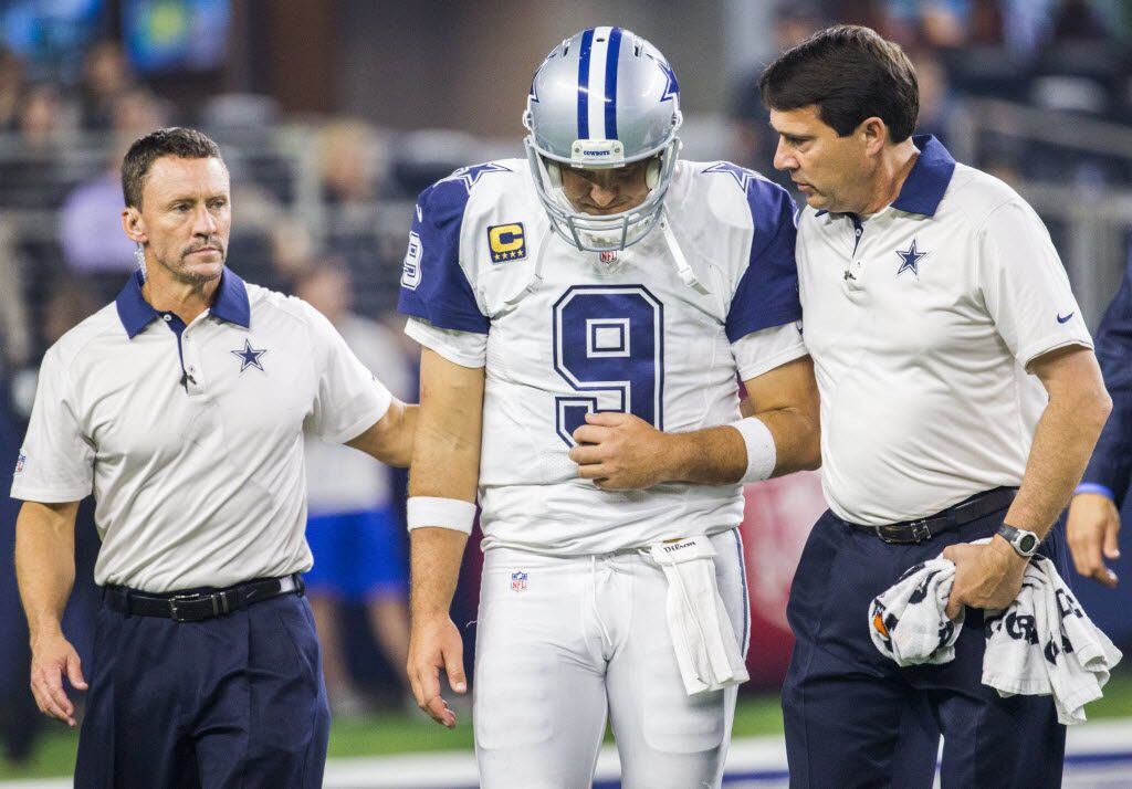 Dallas Cowboys quarterback Tony Romo (9) is helped off the field after an injury during the...