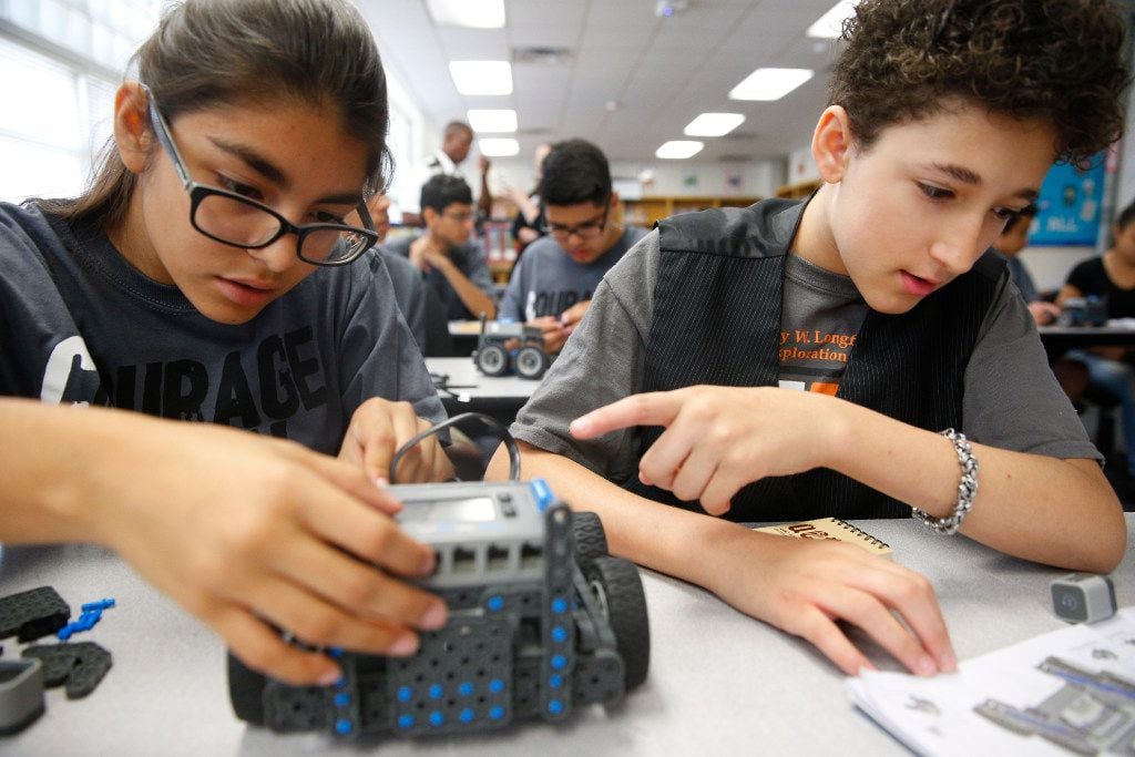 Maria Martinez, 14, (left) and Neryce MacWilliam, 12, put together a VEX robot as students...