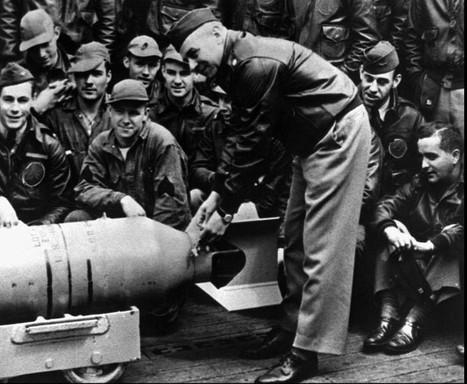 Lt. Col. Jimmy Doolittle, shown fastening a medal to a bomb prior to the launch of the...