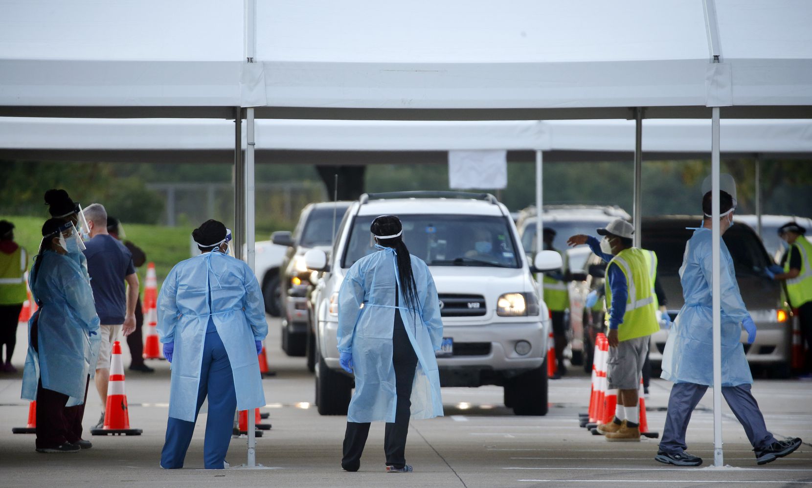 Medical personnel prep and conducted nasal swab tests at a drive-through COVID-19 testing site at Dallas College Eastfield Campus in Mesquite on Aug. 3, 2020.