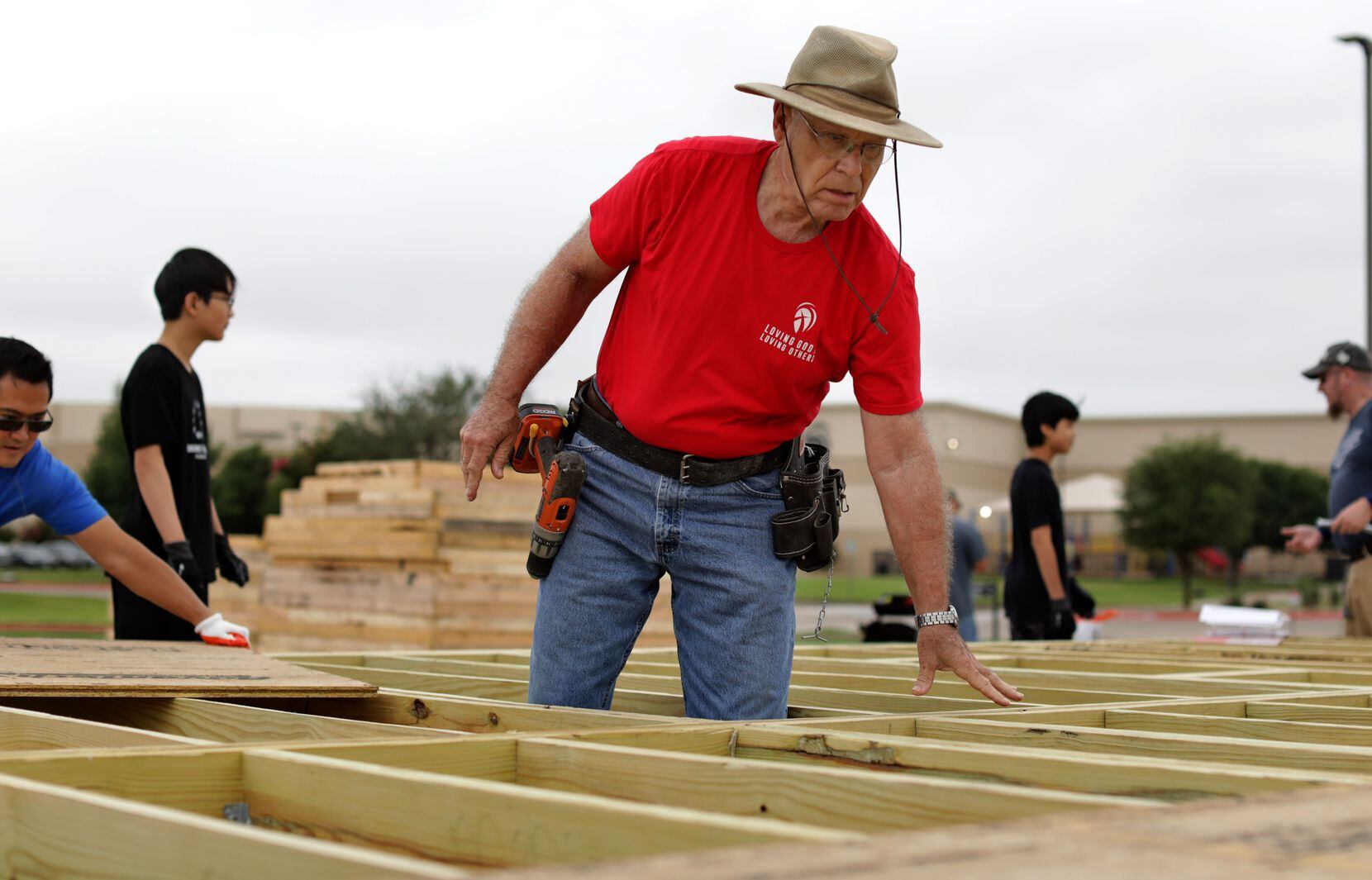 Phil Bird (center) helps to prepare a house built at Cottonwood Creek Church in Allen for shipping to the Rio Grande Valley.