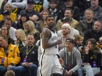Brooklyn Nets guard Kyrie Irving (11) looks on during the first half of an NBA basketball...
