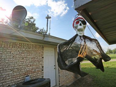 Halloween decorations flutter in the breeze at a home near downtown Moran, Texas,...