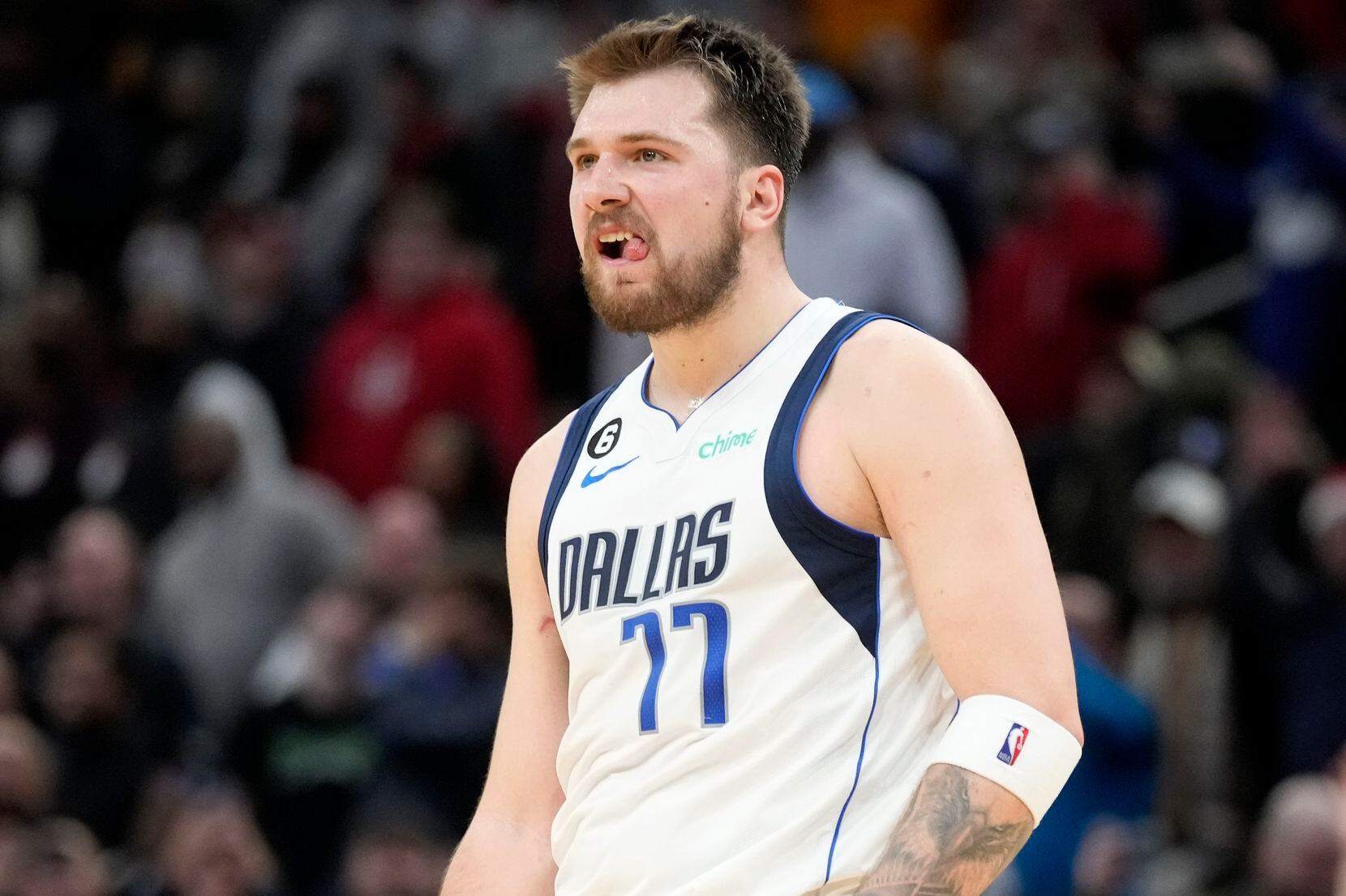 Dallas Mavericks guard Luka Doncic reacts after making a 3-point basket during the second...
