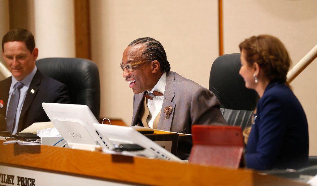 Dallas County Commissioner John Wiley Price smiles while speaking next to County Judge Clay...