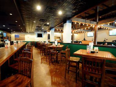 Guests can sit at the bar or tables at Snuffers in Addison, TX on May 7, 2015. (Alexandra...