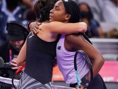 Coco Gauff of the USA, right, and Caroline Garcia of France embrace each other after their...