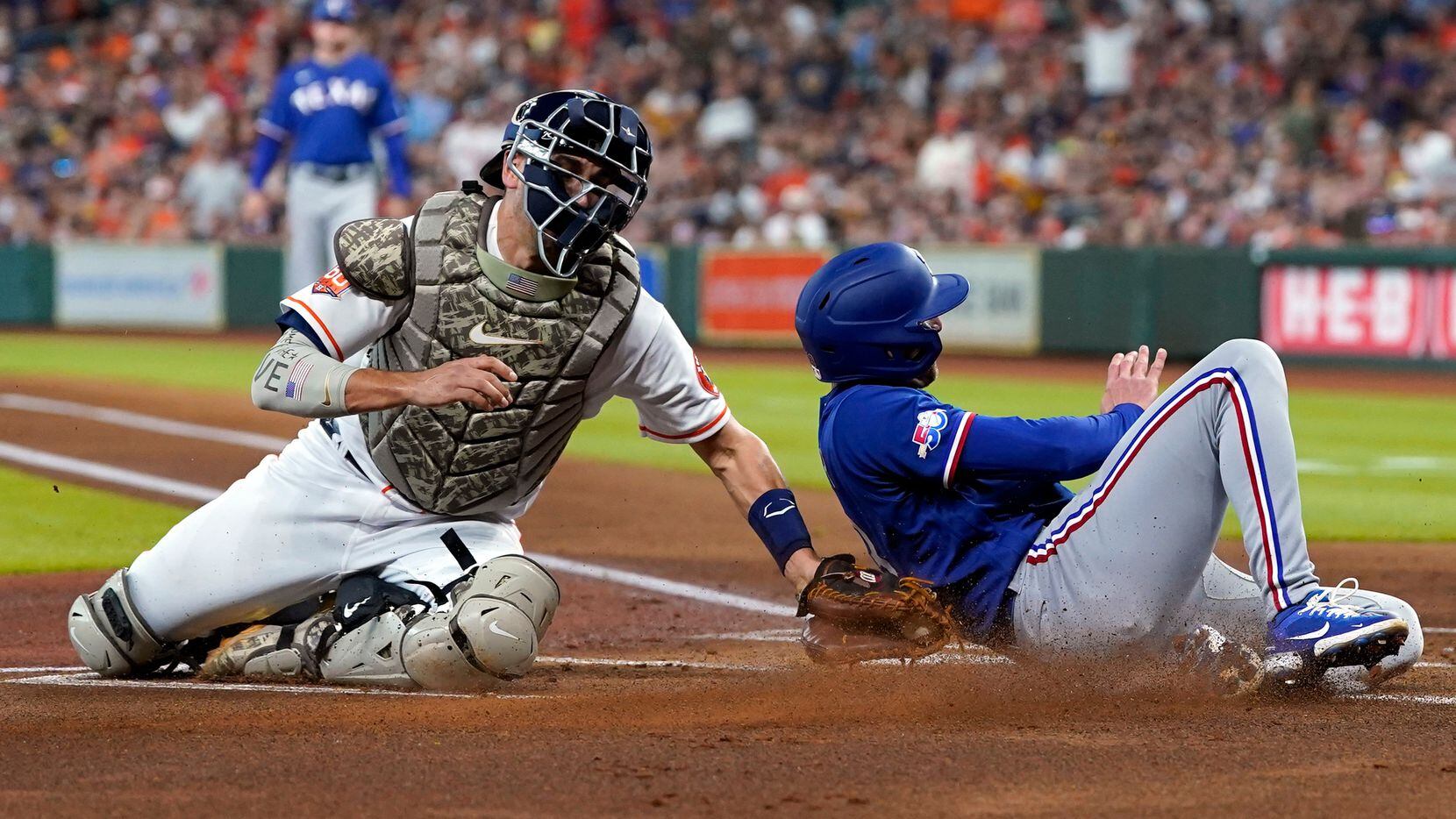 Texas Rangers' Brad Miller, right, is tagged out by Houston Astros catcher Jason Castro...