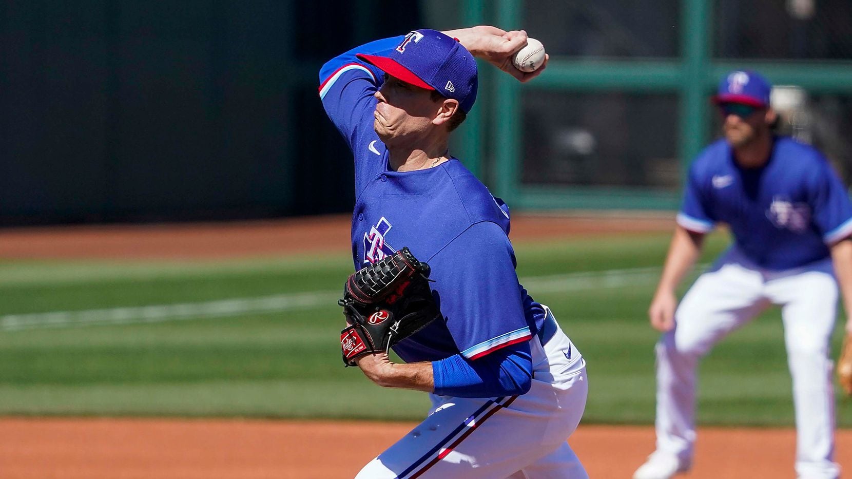 Texas Rangers pitcher Kyle Gibson delivers during the first inning of a spring training game...