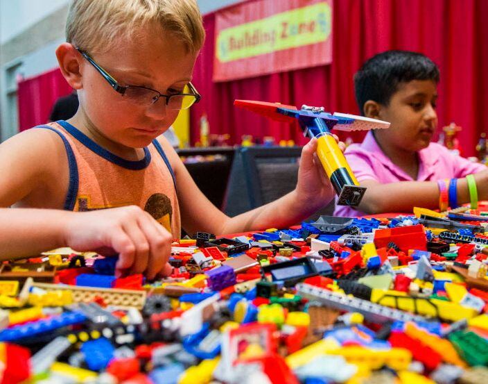 Boys build with Legos during the Lego BrickUniverse fan convention in Plano.
