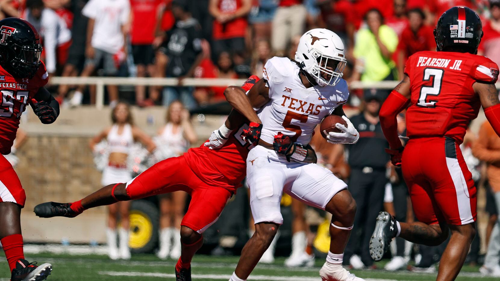 Texas' Bijan Robinson (5) is tackled by Texas Tech's Dadrion Taylor-Demerson (25) during the...