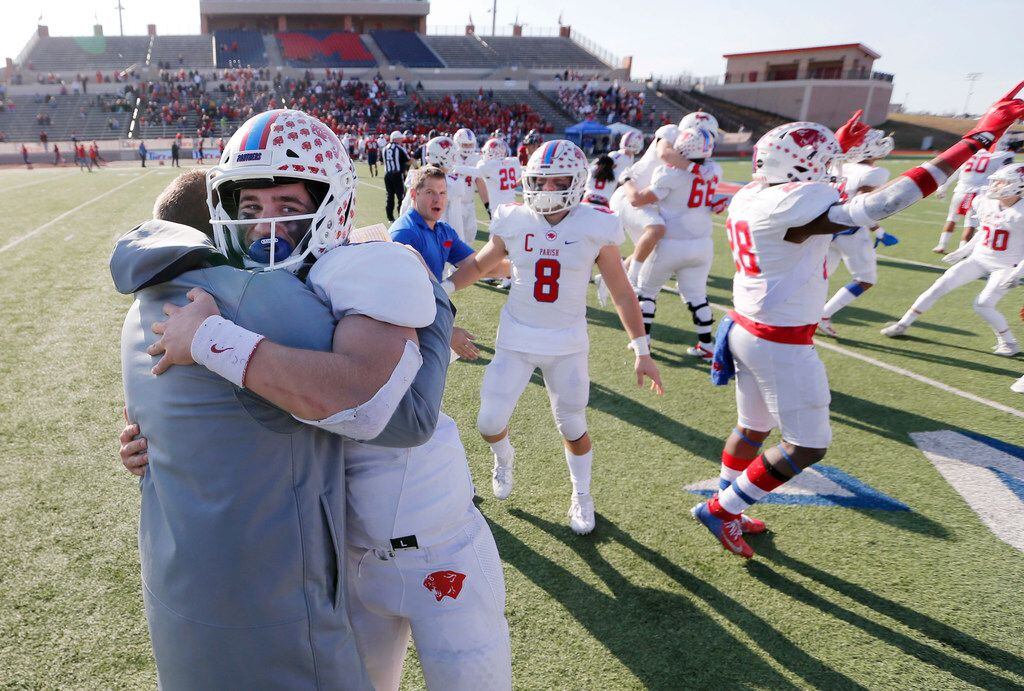 Parish Episcopal's Preston Stone (2) hugs head coach Daniel Novakov in celebration after defeating Plano John Paul II 42-14 in the TAPPS Division I State Championship game at Waco Midway's Panther Stadium in Hewitt, Texas on Friday, December 6, 2019. (Vernon Bryant/The Dallas Morning News)