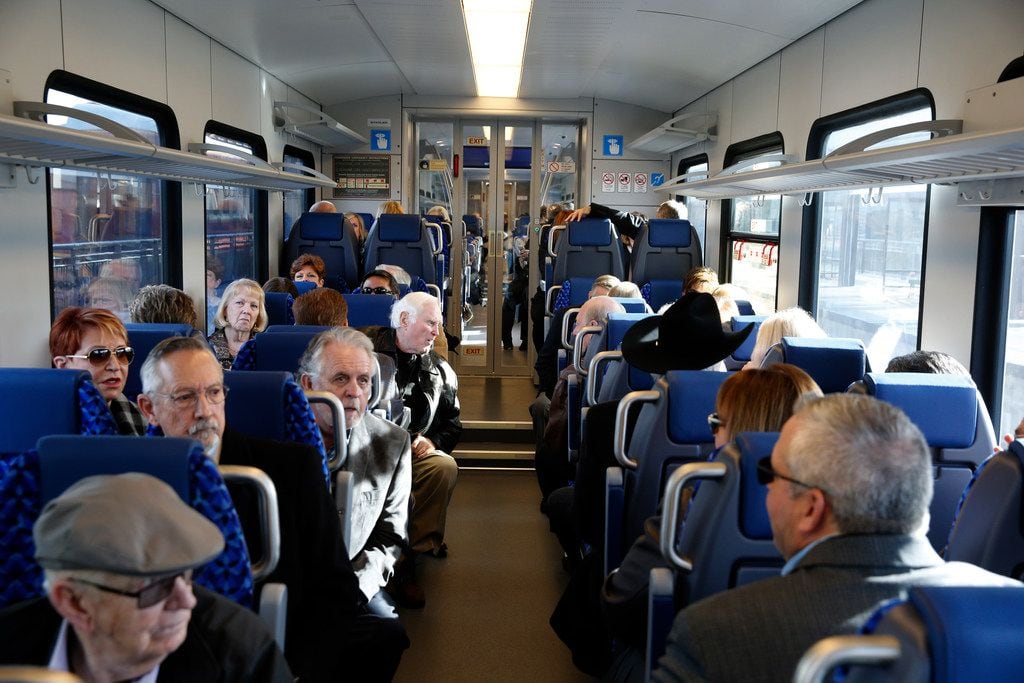 Travelers wait in their chairs for a maiden trip of the Trinity Metro TEXRail to go to DFW...
