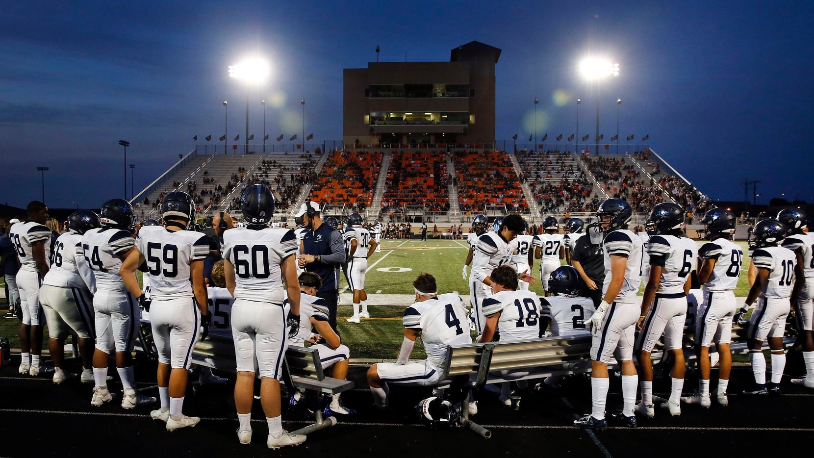 The Frisco Lone Star football team huddles up on the bench as they face Aledo in the first...