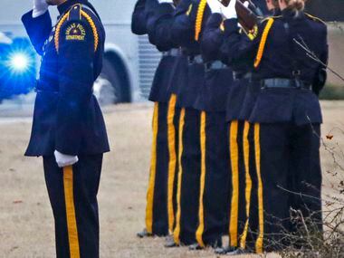 Dallas police officers fire a 21-gun salute for Richardson police officer David Sherrard...