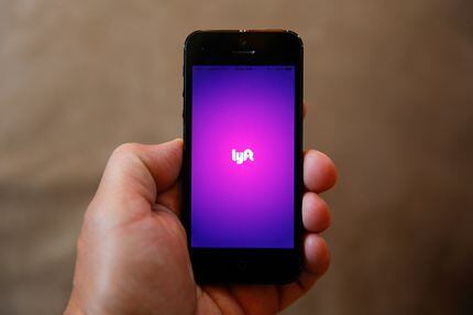 FILE - This Monday, May 16, 2016, file photo shows a smartphone displaying the Lyft app, in...