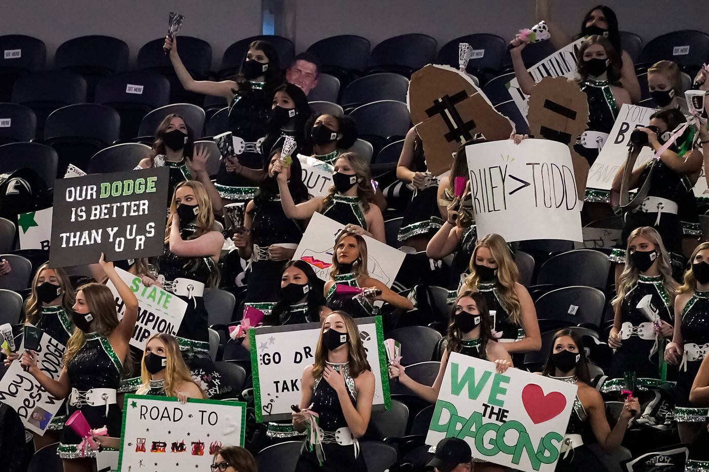 The Southlake Carroll drill team holds signs referencing the matchup between Southlake Carroll head coach Riley Dodge and his father Austin Westlake head coach Todd Dodge during the first quarter of the Class 6A Division I state football championship game at AT&T Stadium on Saturday, Jan. 16, 2021, in Arlington, Texas. (Smiley N. Pool/The Dallas Morning News)
