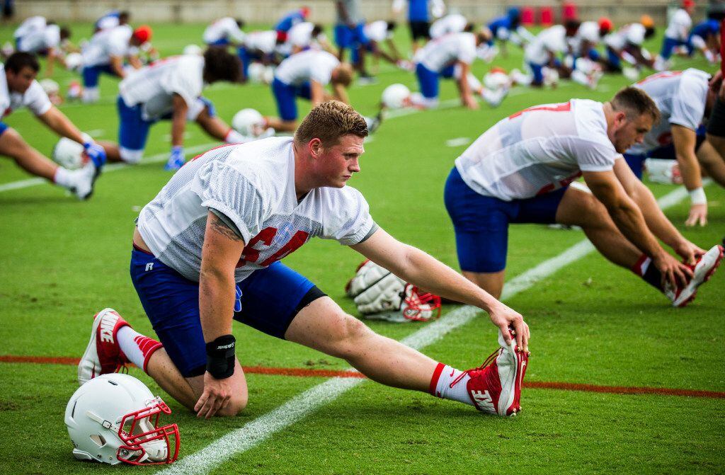 Offensive lineman Bryce Wilds (64) stretches during SMU's first football practice of the...