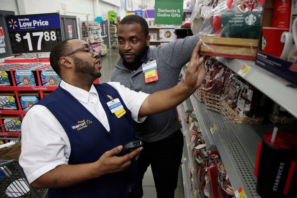 In this Thursday, Nov. 9, 2017, photo, Walmart employee Kenneth White, left, is coached by...