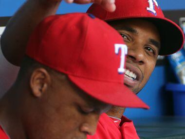 Texas shortstop Elvis Andrus playfully bothers teammate Adrian Beltre on the bench in the...