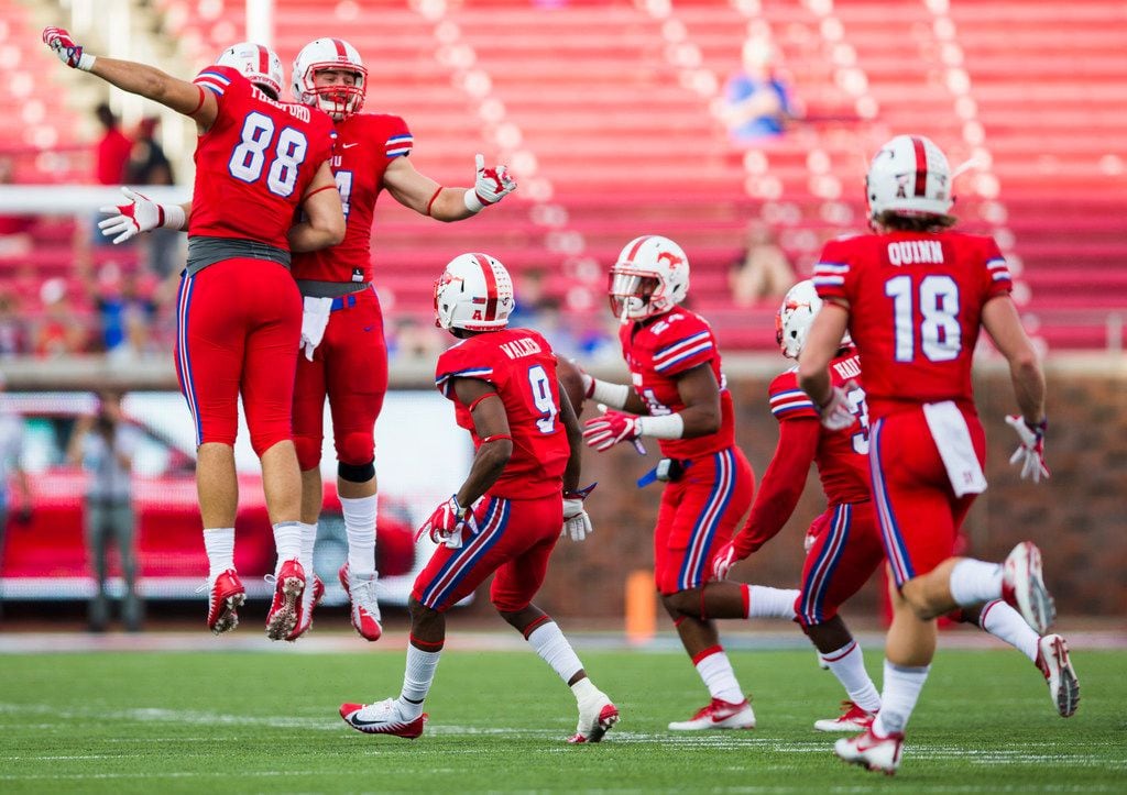 Southern Methodist Mustangs celebrate after safety Delano Robinson (24) recovered a fumble...