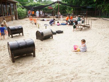Children play while their parents enjoy food and drinks at The Lot in Dallas, Texas on...