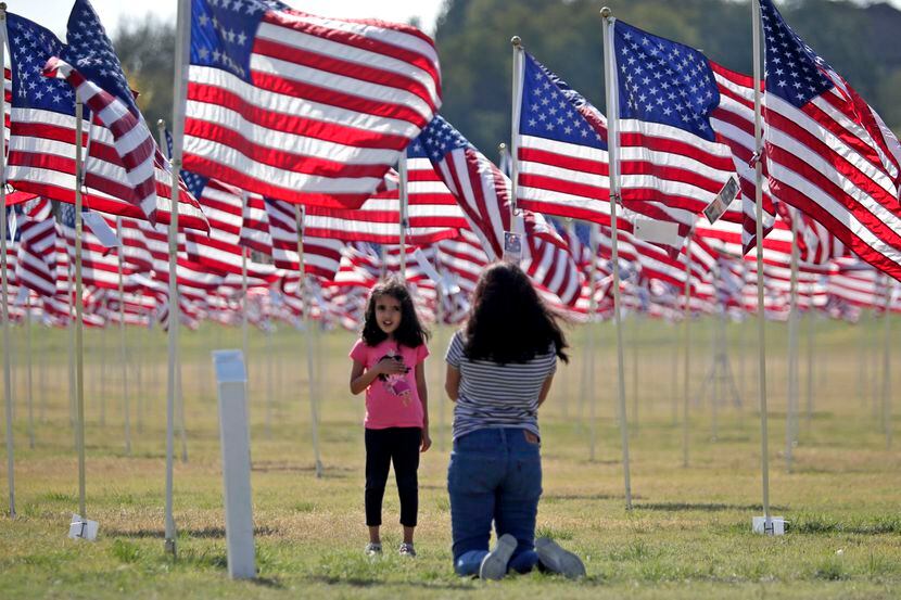Ira Ravi, 5, and her mother, Bratibha, visit the Plano Flags of Honor at Oak Point Park. The...